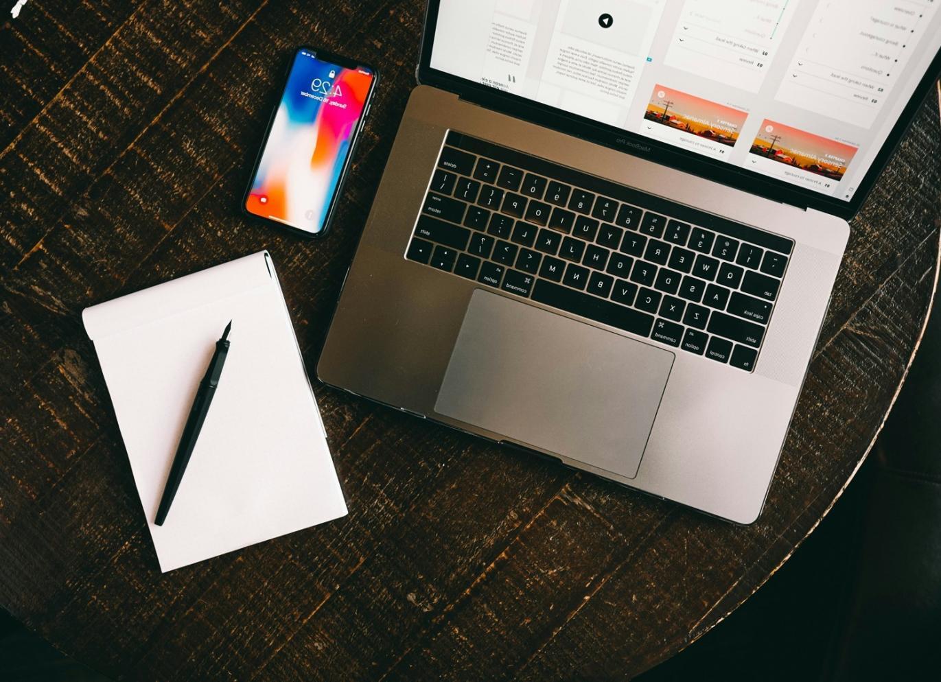 Students collaborating on web design projects in modern classroom